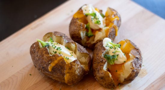 Air fried baked potato topped with cheese, sour cream and broccoli